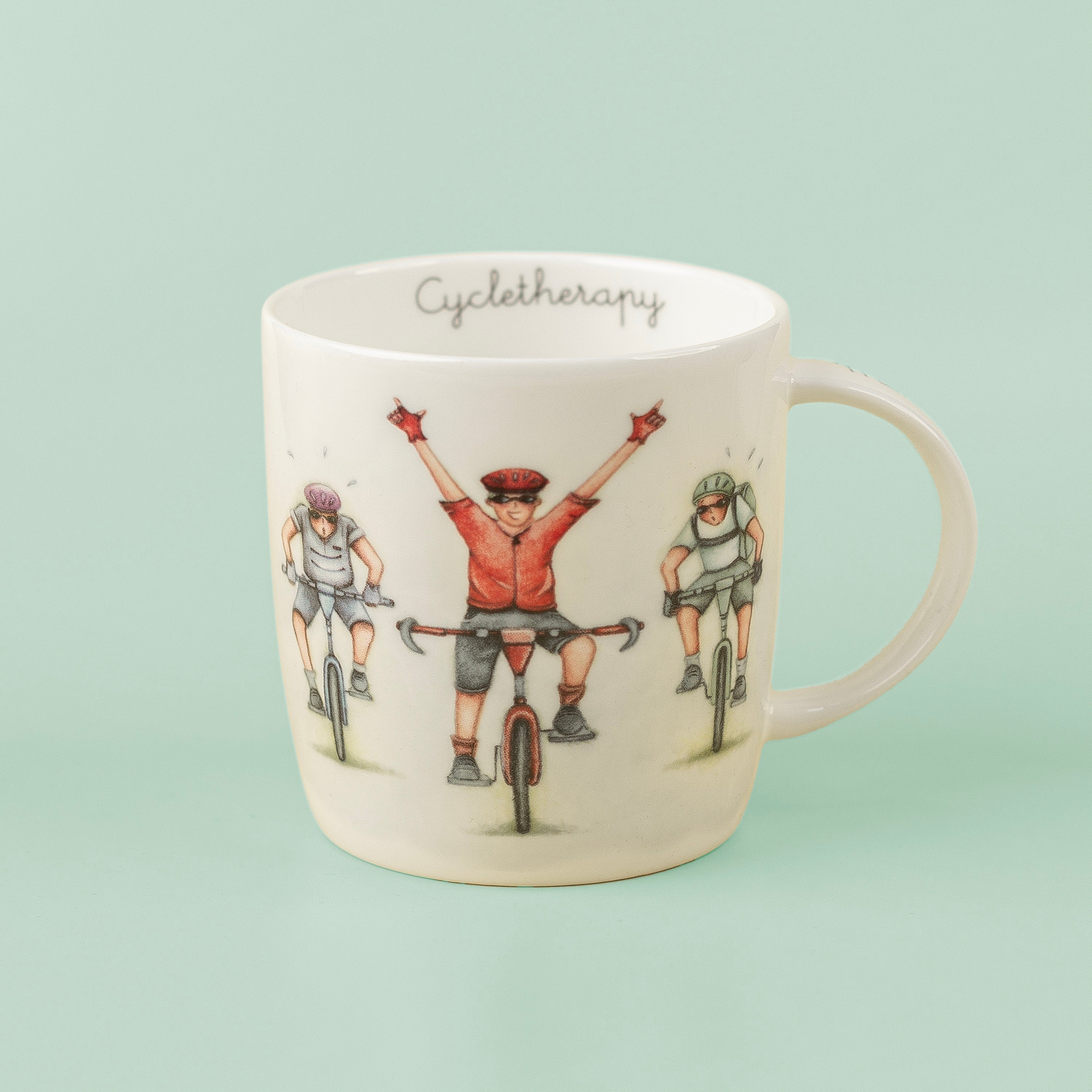 A white fine china mug with a printed illustration of three cyclists and the text 'Cyclotherapy'.
