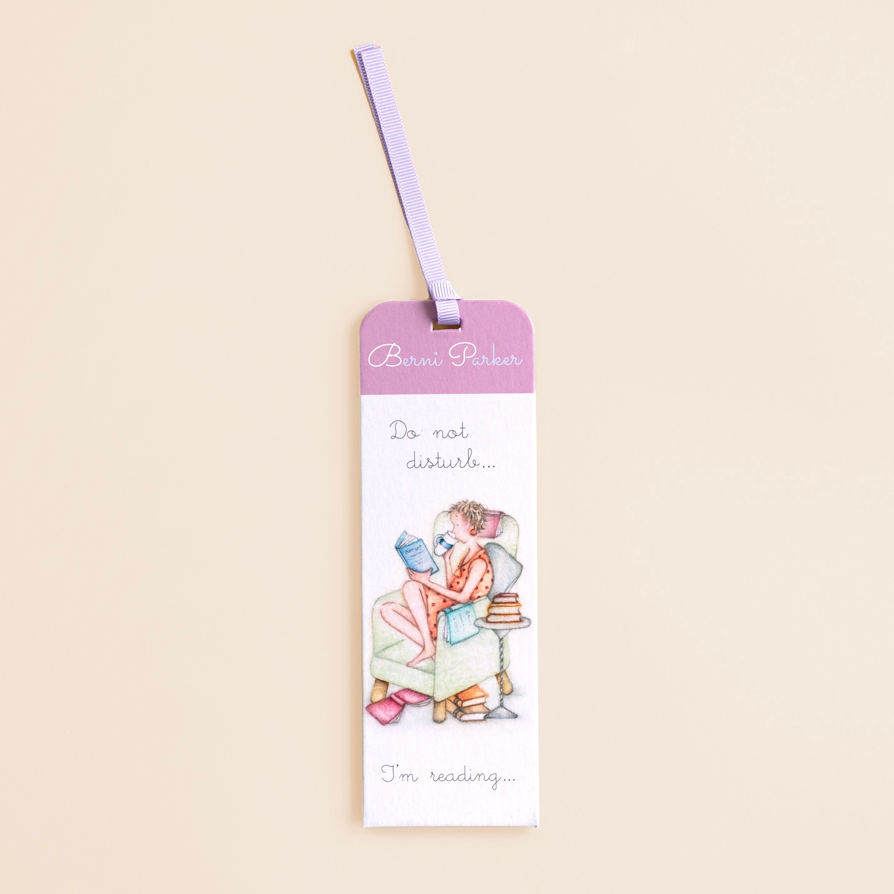 A bookmark with a illustration of a women reading a book, with the text 'Do not disturb..I'm reading'