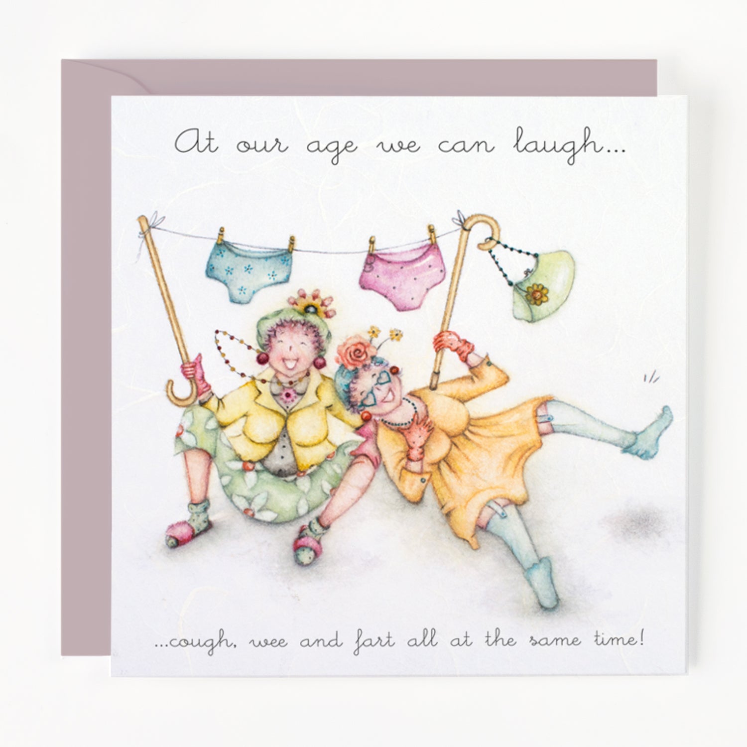 Illustration of two elderly women underneath underwear hanging on a line, with humorous text 'At our age we can laugh, cough, wee and fart all at the same time!'
