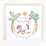 A greeting card with an illustration of pineapples, a deck chair, sunglasses, a cocktail, and the text 'Happy Retirement' and 'Living the good life'.