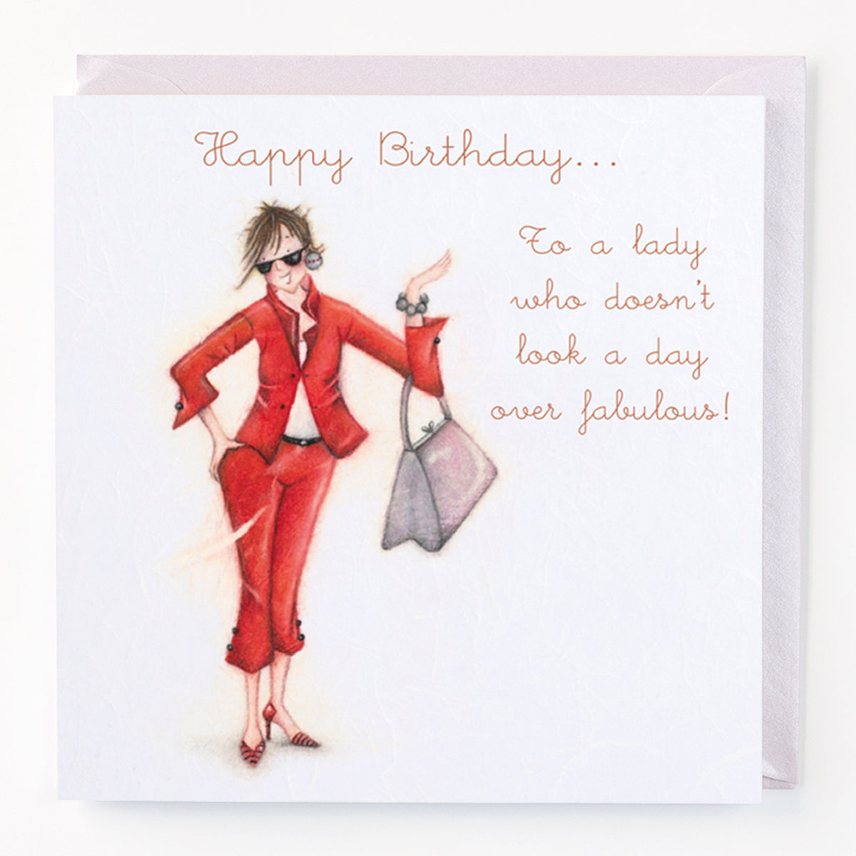 A birthday card with an illustration of a fashionable woman in a red outfit. The card has text 'Happy Birthday to a lady who doesn't look a day over fabulous!'.